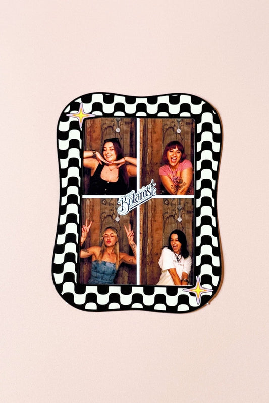 Small rectangular tray with checkered border featuring four photos of a woman on a beige background.