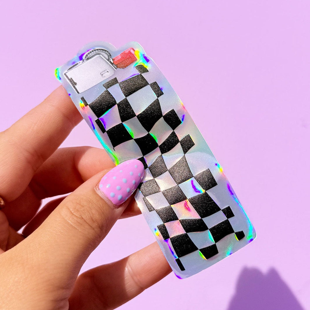 Hand holding a holographic checkered phone case against a purple background