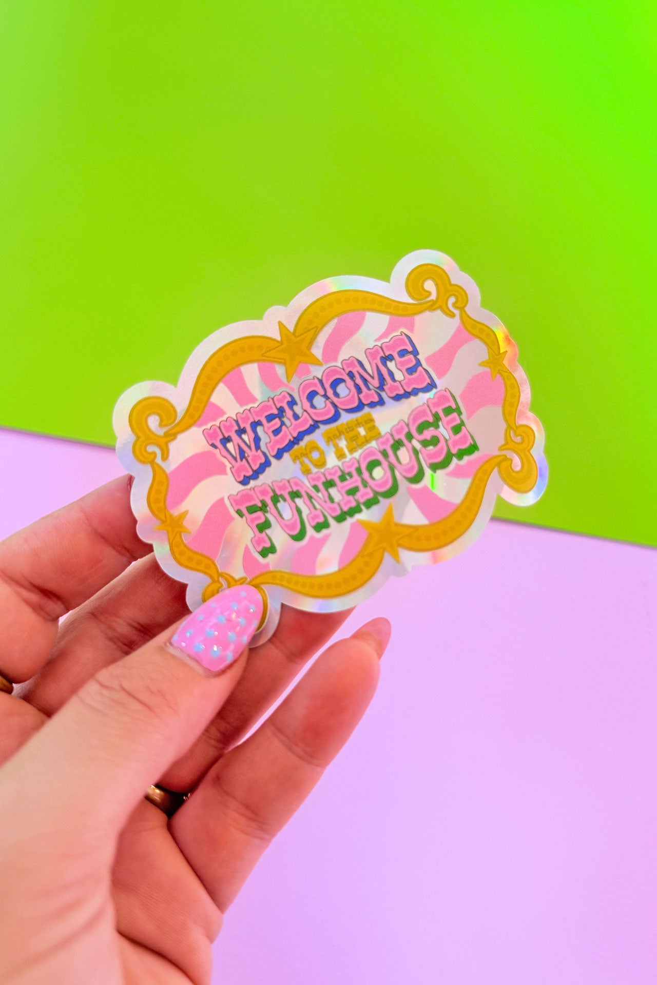 Sticker with 'Welcome to the Punchouse' text held by a hand against a green and purple gradient background