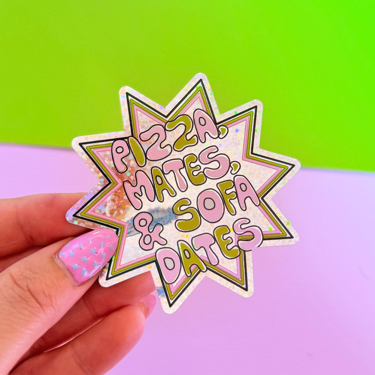 Sticker with 'Pizza Mates & Sofa Dates' text held by a hand against a gradient background